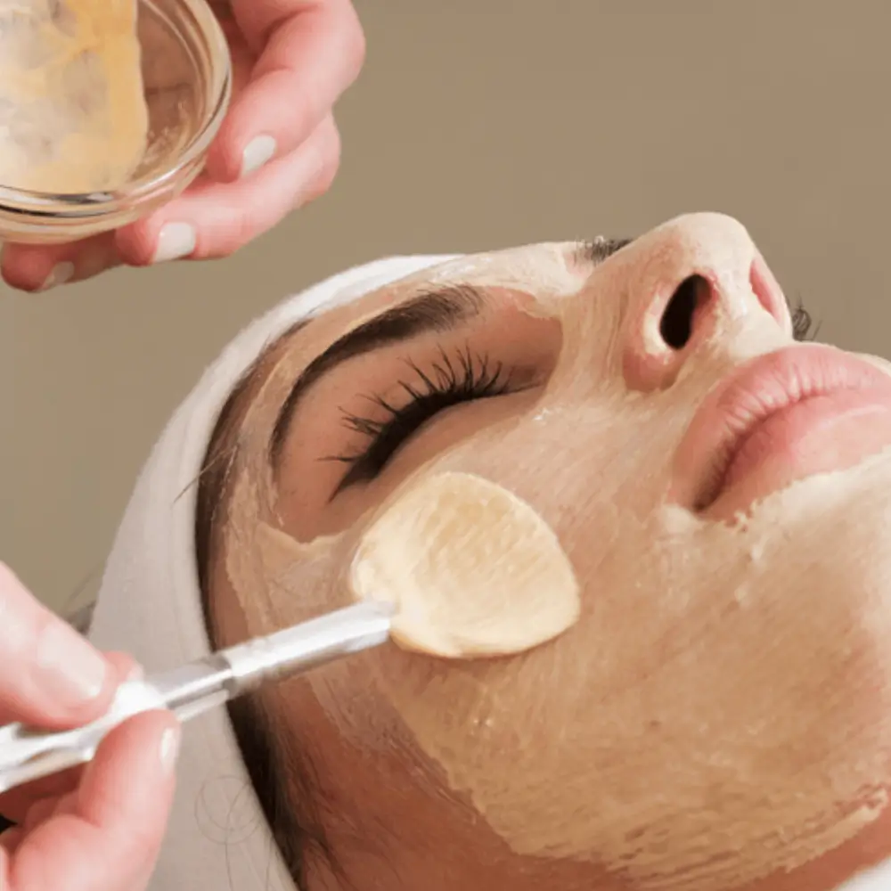 woman lying down while a face mask is applied by a los gatos esthetician