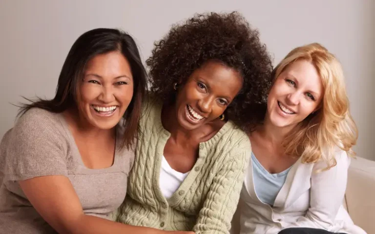 3 mid-life women vibrant laughing diverse skintones representing menopause skin support and confidence.